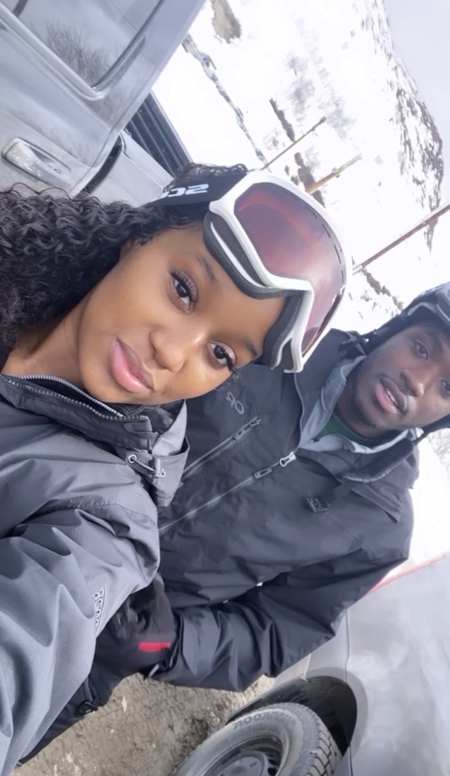 Amaya and her husband bundled in ski gear and goggles on a snowy day.